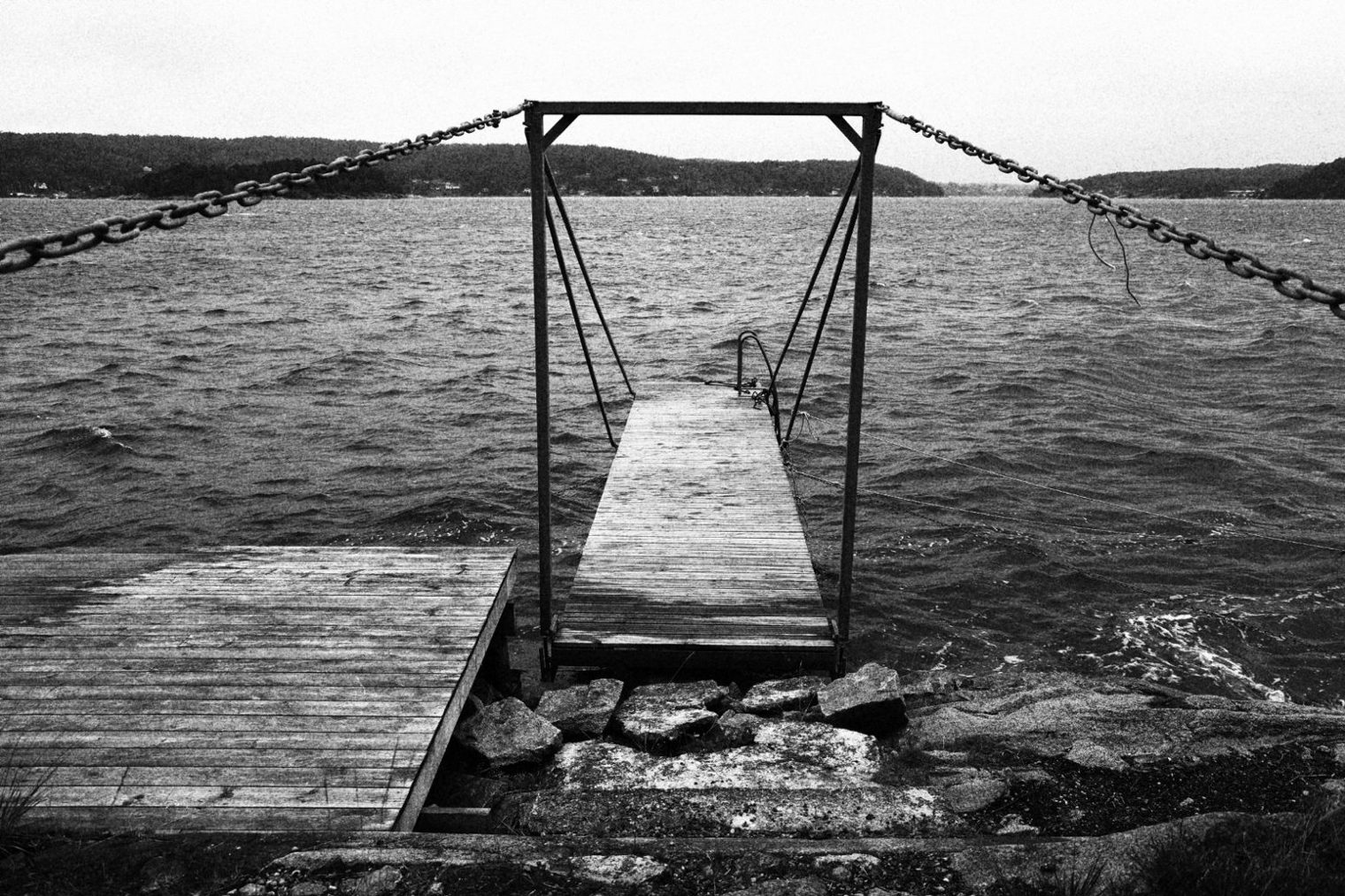 A wooden pier reaching out over calm water