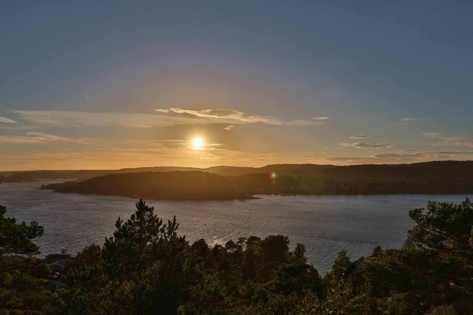 The sun setting over the horizon